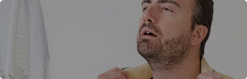 Man spreading shirt collar to fan himself from the Tampa FL heat and humidity