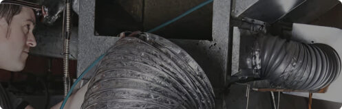 Technician working on air ducts in Tampa, FL