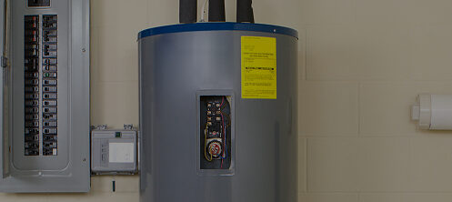 Water heater in the basement next to an electrical panel