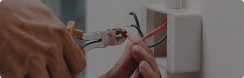 Electrician repairing wires in an outlet