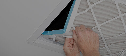 Person switching out an air filter