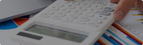 Person calculating costs with a calculator